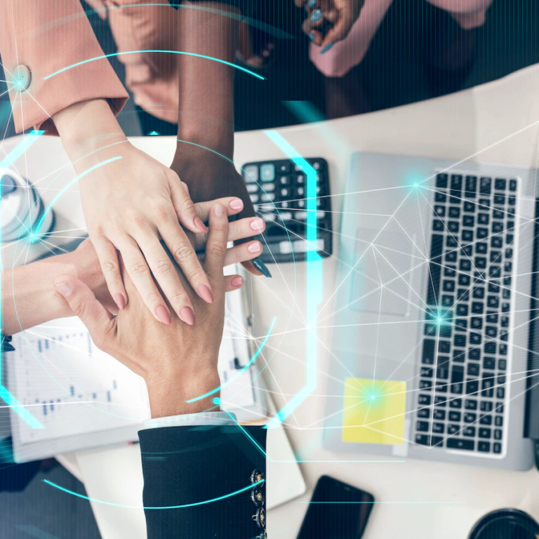 Team collaborating in front of a laptop, symbolizing teamwork for business growth